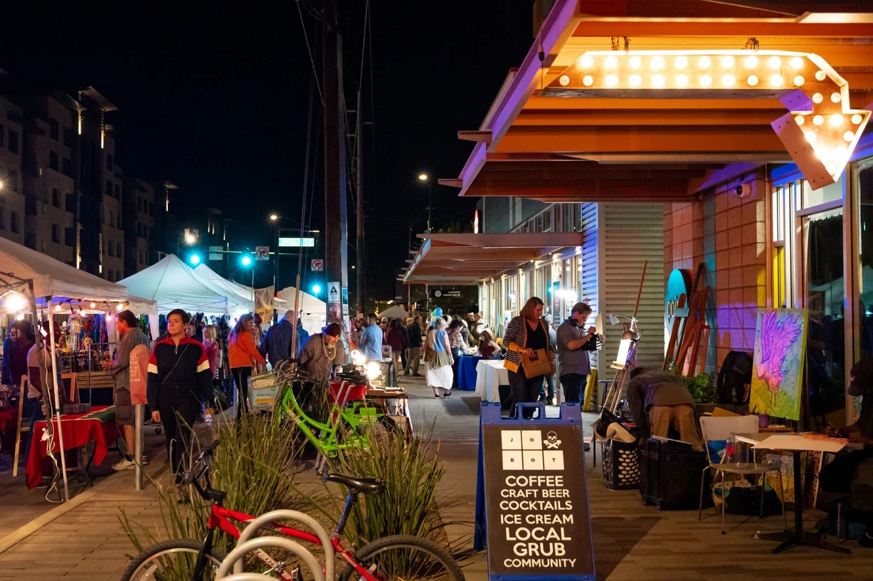 Visitors exploring art stalls and local businesses during First Friday on Roosevelt Row in Phoenix